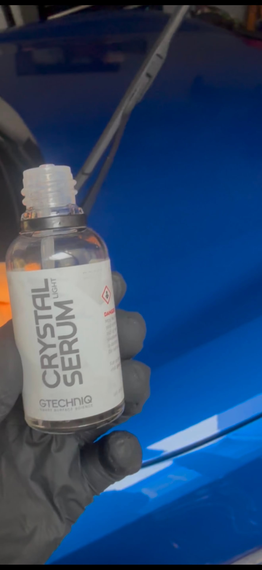 Professional ceramic coating being applied to a blue car in Melbourne's north