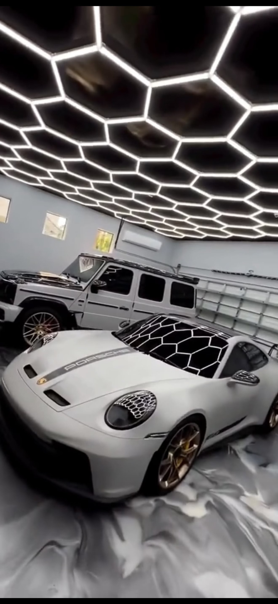 Professional paint correction and ceramic coating by ACC Car Detailing Melbourne, Porsche 911 GT3 and G-Wagon under hexagon studio lighting